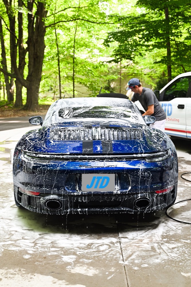 Porsche 911 under foam during a Just The Details wash